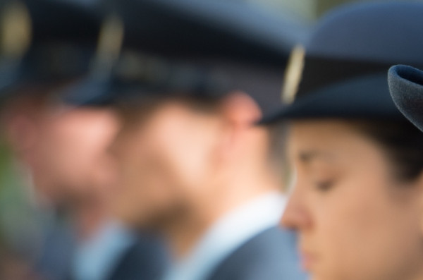 NZDF members standing to attention, with their faces blurred