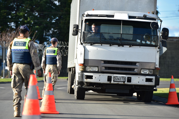 Military Police stopping a truck at a checkpoint
