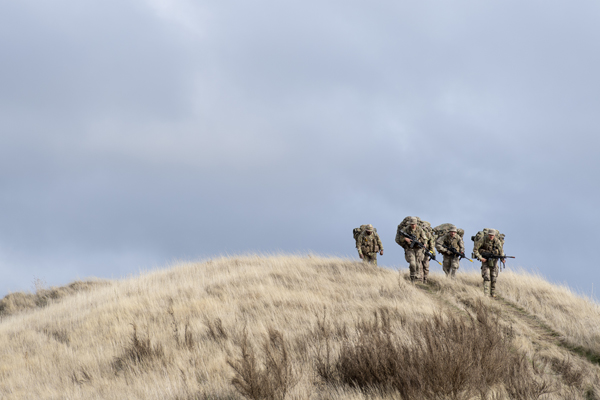 NZDF personnel marching over a hill