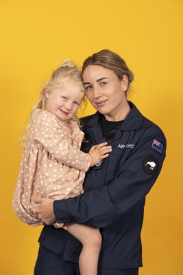 Air Force member holding her daughter