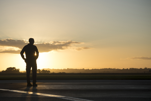 NZDF member standing outside as the sun rises