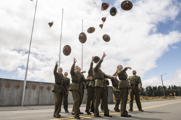 NZDF personnel tossing their hats into the air